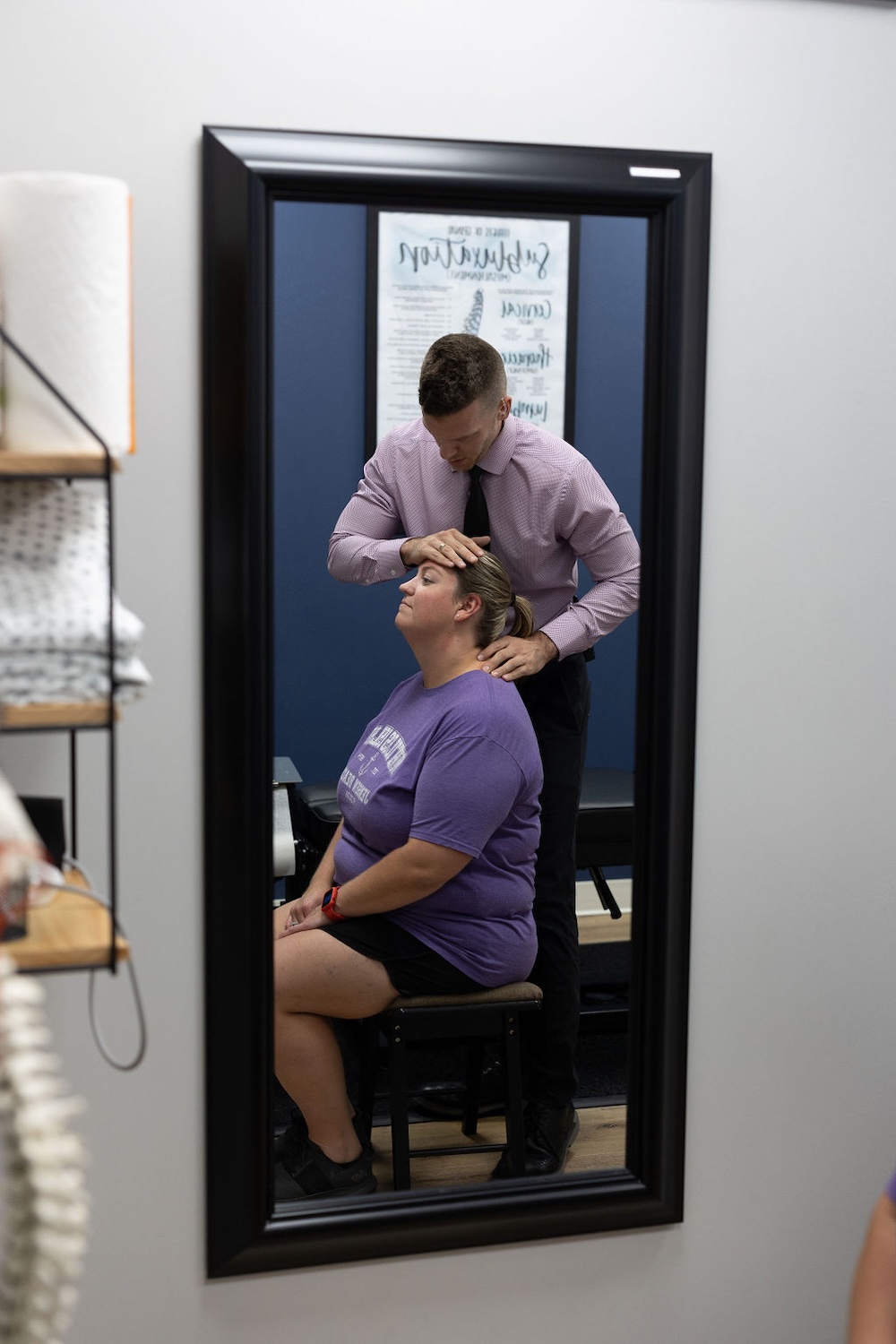 Dr. Nicholas Esser giving the woman a headache therapy
