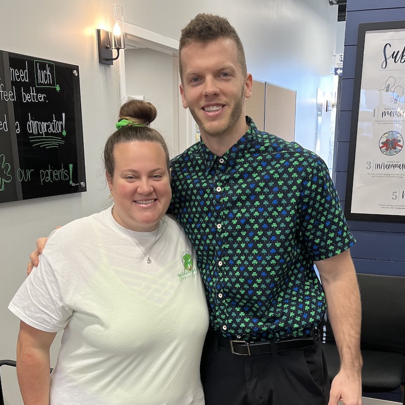 Chiropractor standing with a patient in a clinic setting, representing personalized chiropractic care and treatment success.